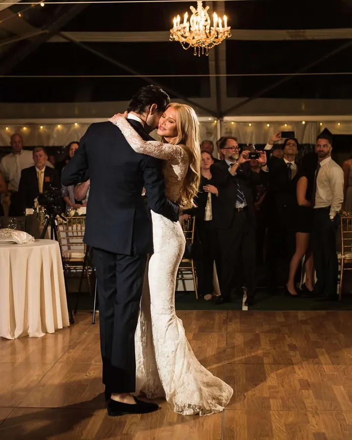Elizabeth and Sacha dancing at their wedding, guests watching