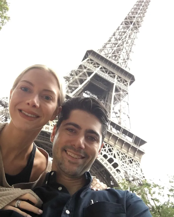 Elizabeth and Sacha taking a selfie under the Eiffel Tower