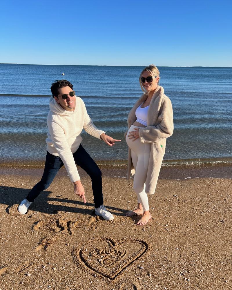 Elizabeth and Sacha on a New England beach, a heart drawn in the sand
