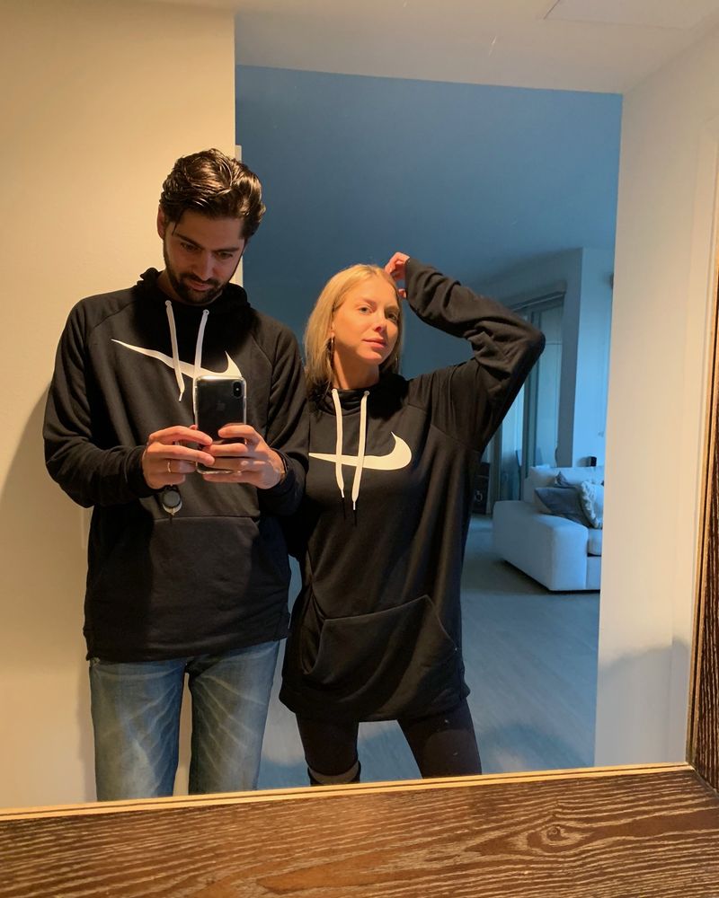Elizabeth and Sacha in matching hoodies, photographed in a mirror